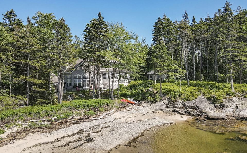 View from rocky ledge protecting beach back to house.