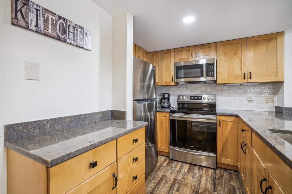 Fully equipped kitchen featuring modern finishes, stainless appliances, and plenty of prep space.