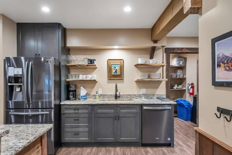 The kitchen boasts ample counter space, beautiful cabinets and woodwork, stainless steel appliances, and all the basic cookware to easily whip up some delicious meals at home.