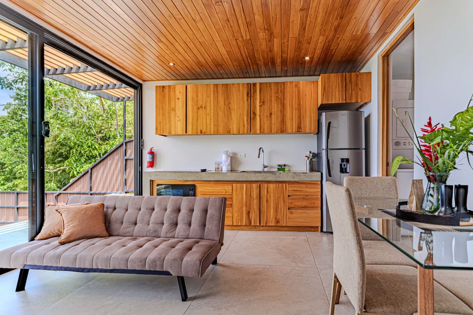 Open living and kitchen space with warm wood finishes.