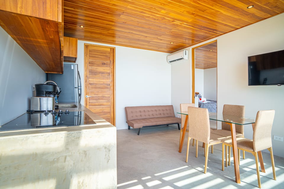 Open-concept living, dining, and kitchen area with warm natural finishes.
