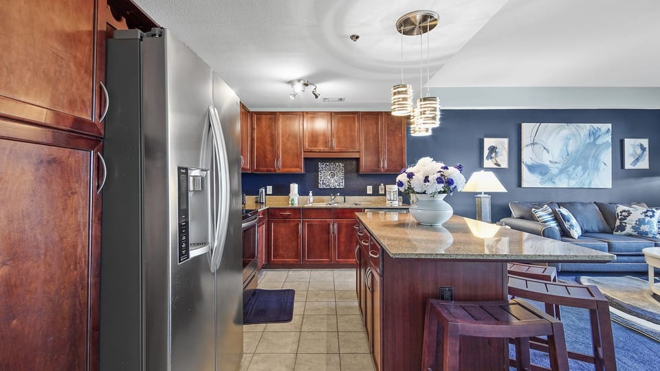 modern kitchen with stainless steel appliances and a large island for dining