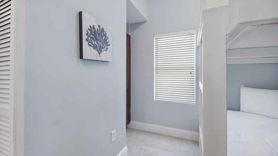 natural light fills this compact, modern hallway with soft blue walls and simple decor.