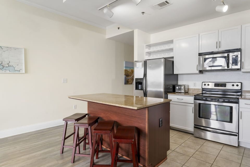 modern kitchen with stainless steel appliances and a central island with seating