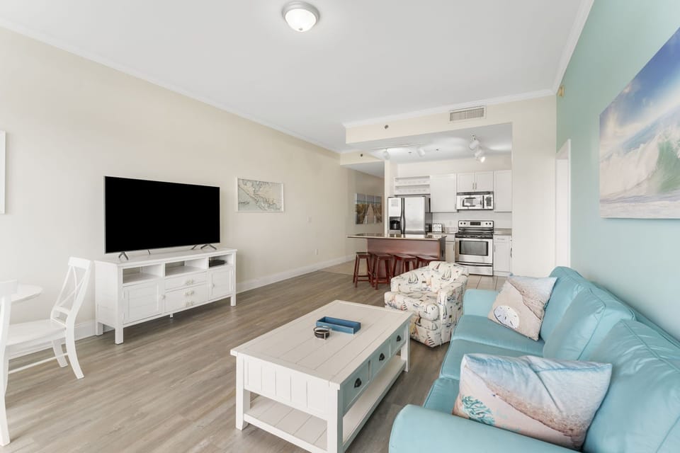 Open living area with modern kitchen and comfortable seating for relaxing or entertaining.