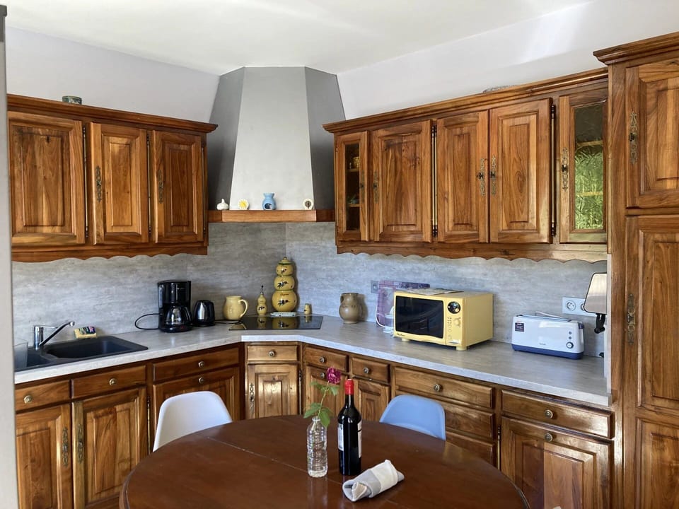 Kitchen equipped with two fridge freezers, dishwasher, oven, hob, microwave.