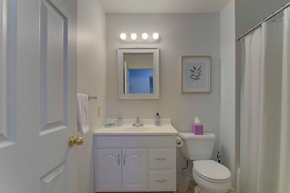 Clean, bright bathroom with a spacious vanity, mirror, and fresh towels for your stay.