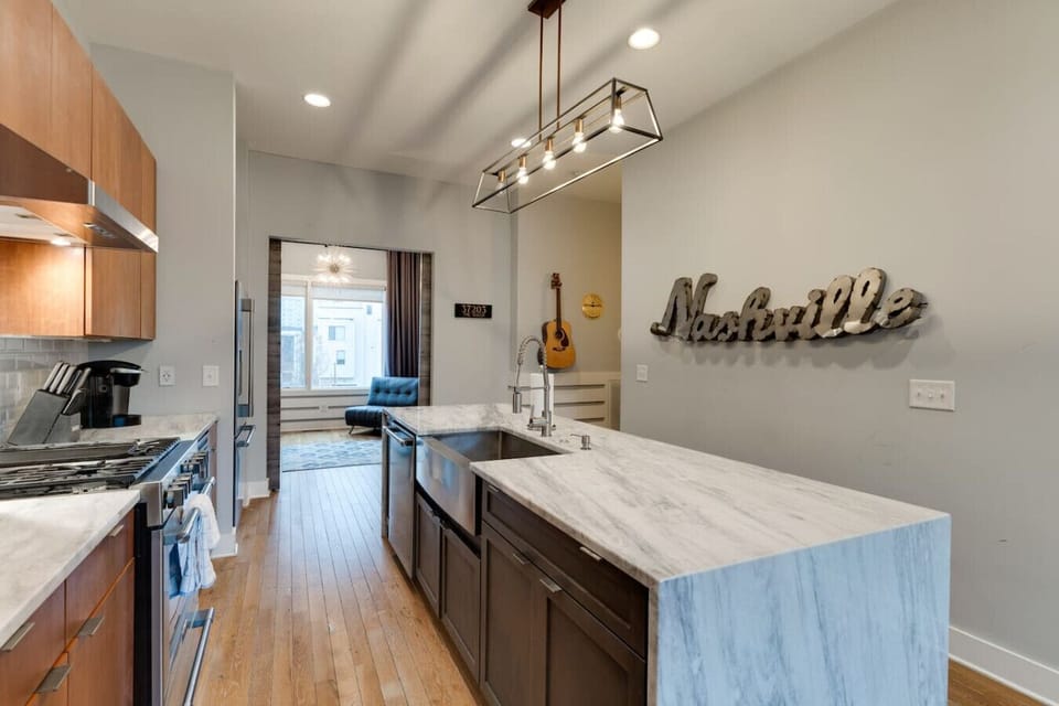 Well‑equipped kitchen with a stove, refrigerator, and plenty of cabinets for storage.