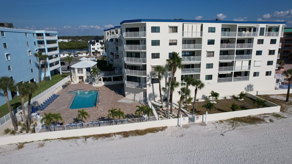 West Side Facing the Beach and Heated Pool area with BBQ
