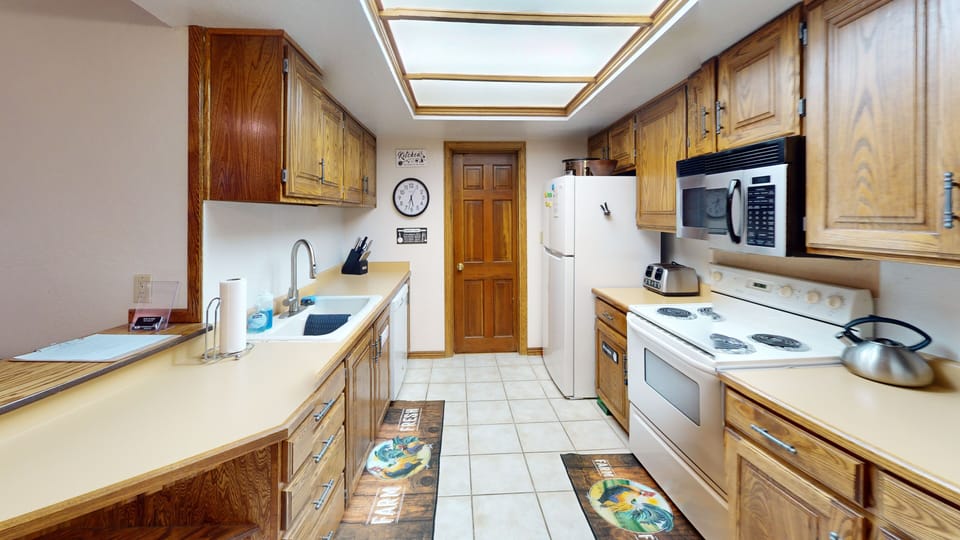 Full Kitchen w/ stove, oven, microwave & dishwasher. entrance to bathroom #2.