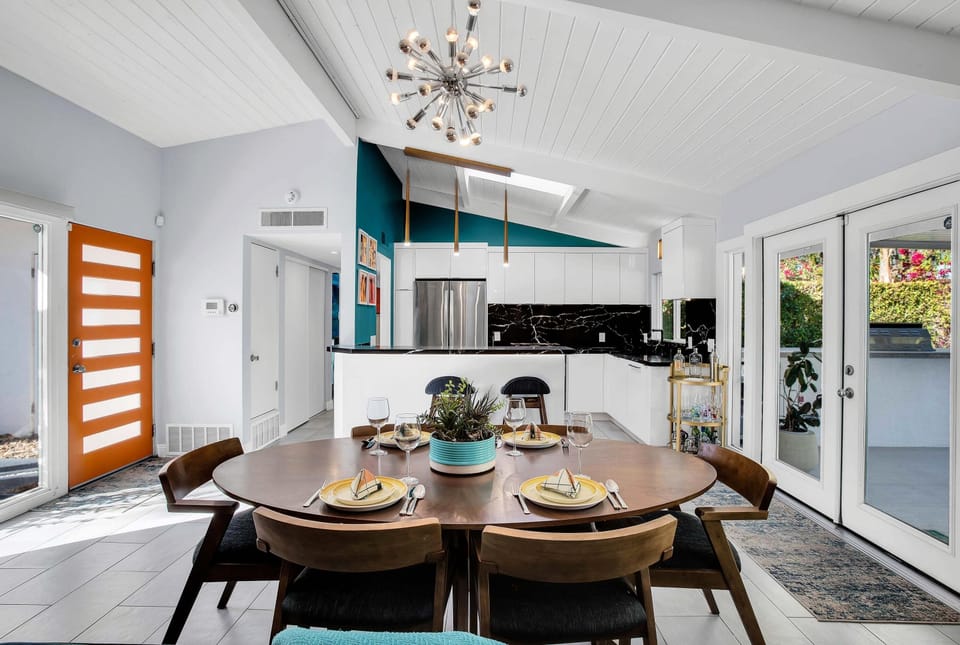 Dine in style in this elegant dining room featuring a beautifully crafted table for six, a sparkling crystal chandelier, and a cozy fireplace. The space creates a warm and inviting atmosphere perfect for family meals or elegant dinner parties. Salut!