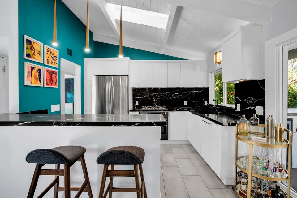 Gather around the stylish kitchen bar with seating for two. Featuring stainless steel appliances, sleek countertops, and ample cabinet space, it's the perfect space to cook and gather with family and friends, creating delicious memories together.