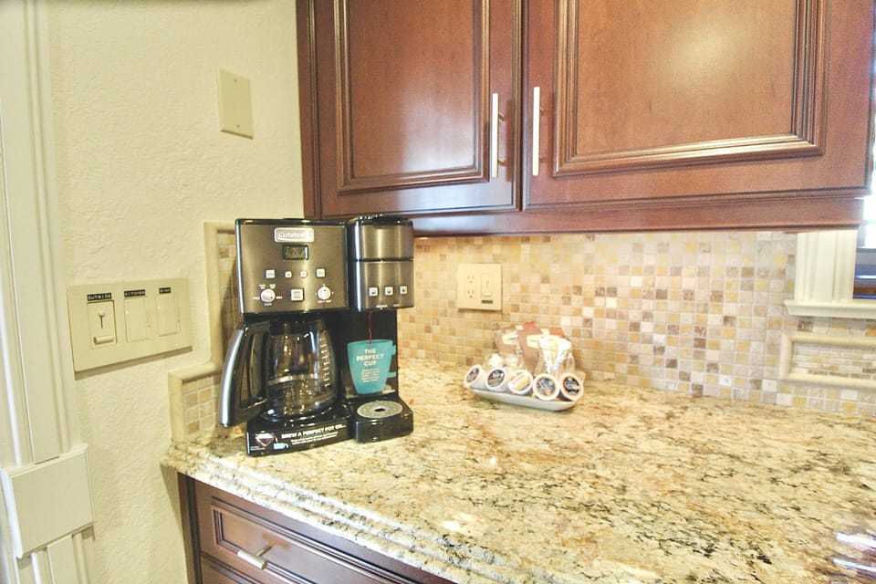 The coffee bar area has a dual coffee pot and keurig machine.