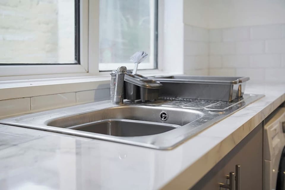 Kitchen equipped with all essentials, including a washer & dryer, oven, fridge and full cookware set.