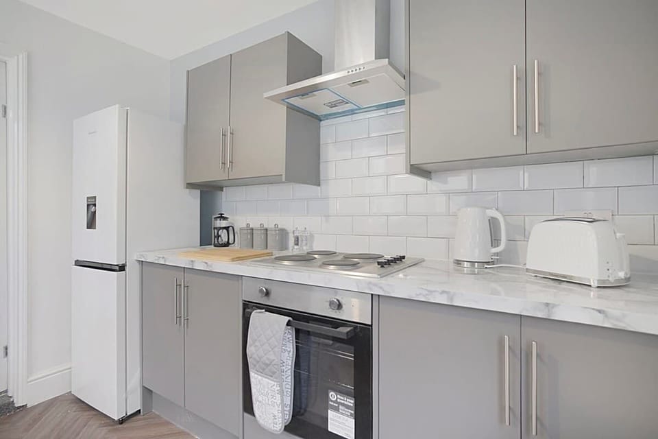 Kitchen equipped with all essentials, including a washer & dryer, oven, fridge and full cookware set.