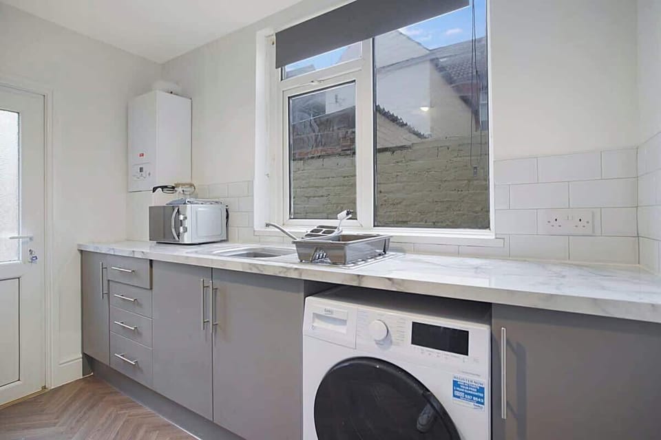 Kitchen equipped with all essentials, including a washer & dryer, oven, fridge and full cookware set.