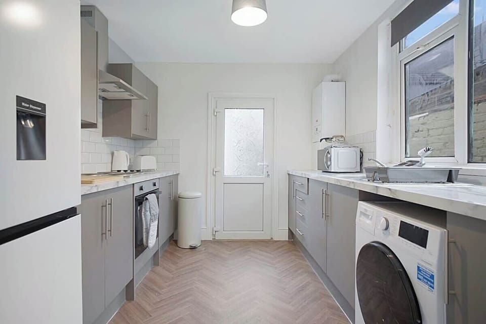 Kitchen equipped with all essentials, including a washer & dryer, oven, fridge and full cookware set.