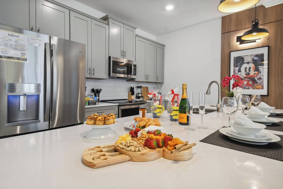 Welcome to this stylish kitchen with sleek gray cabinetry and quartz countertops, perfect for your culinary adventures. Enjoy gourmet treats at the elegant dining table, ideal for unwinding and celebrating special moments.