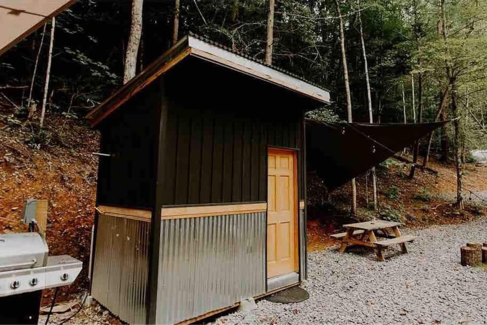 Private bathhouse with hot shower, flushing toilet, and vanity