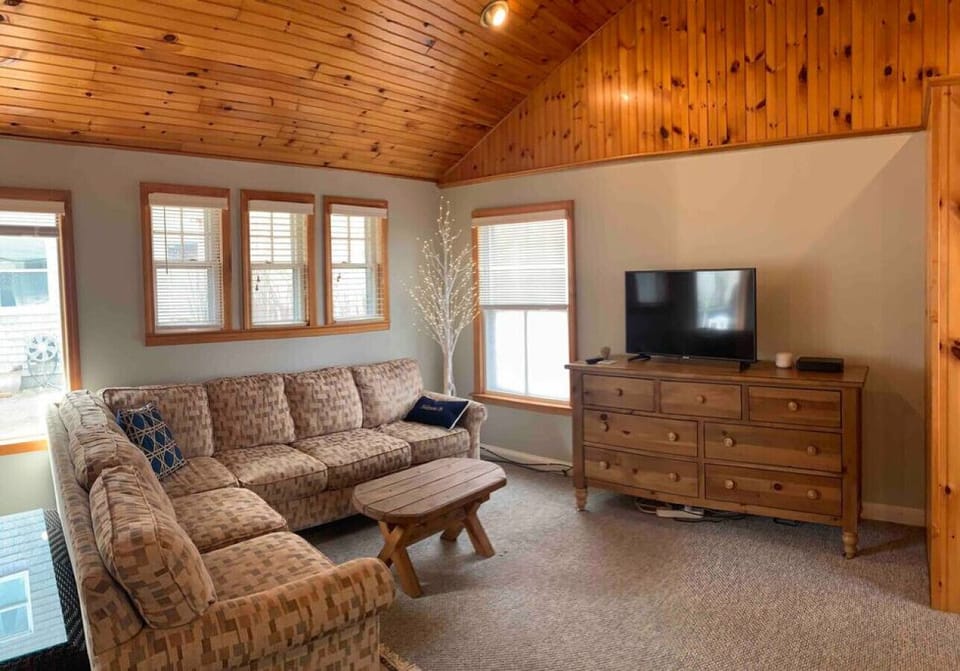 Relax in the living area with sectional and large smart  TV