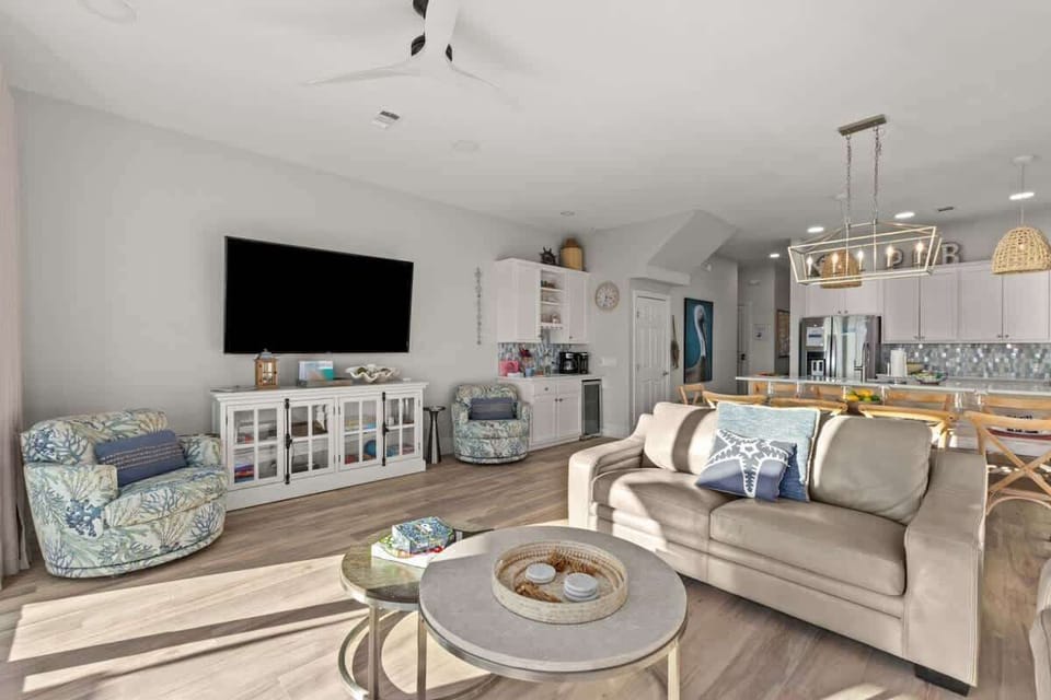 A spacious living room with TV and an open layout Kitchen