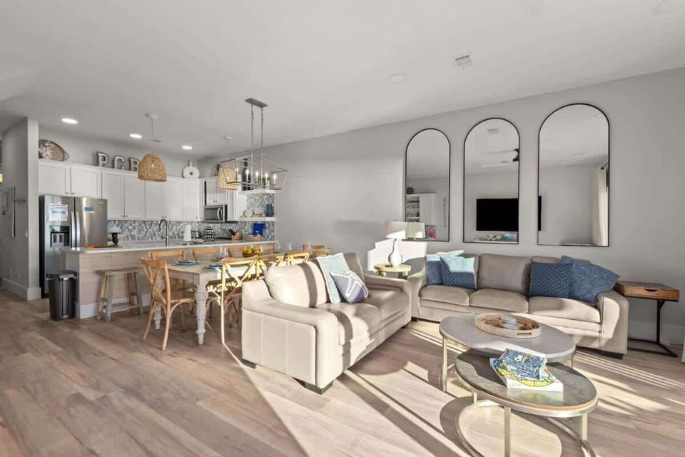 A spacious living room with TV and an open layout Kitchen
