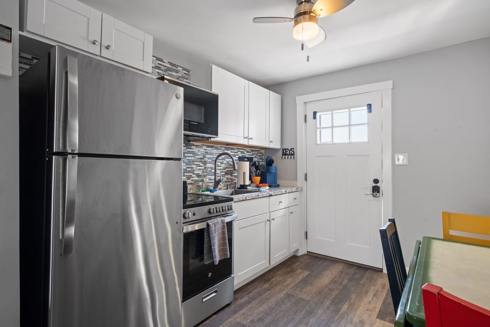 Kitchen equipped with modern appliances.
