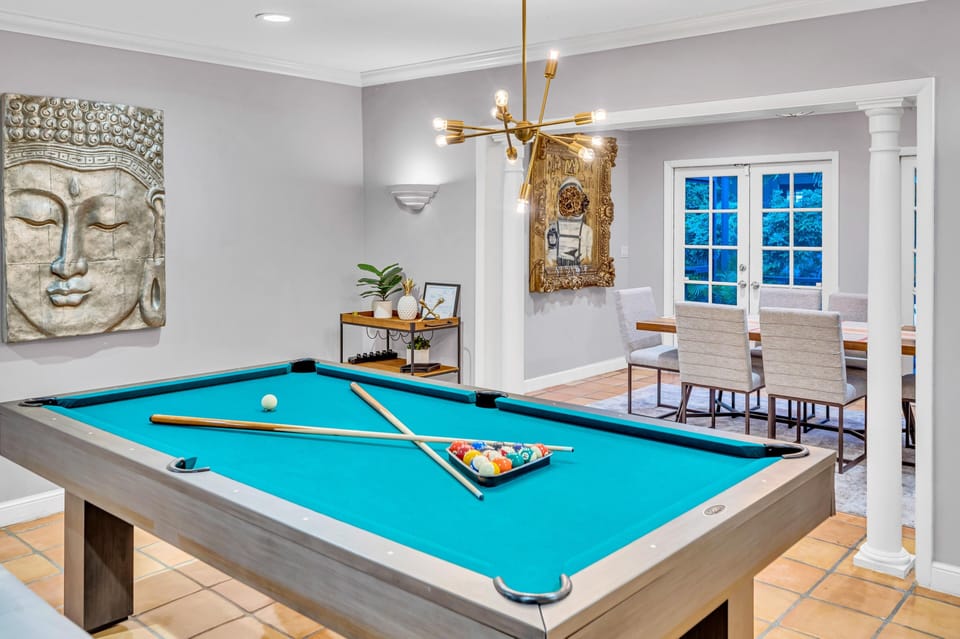 The living room with its pool table offers seamless access to the family and dining room.