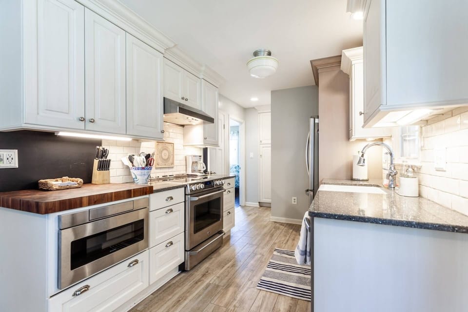 The kitchen is fully-stocked to cook a family meal with cookware, dinnerware and silverware.