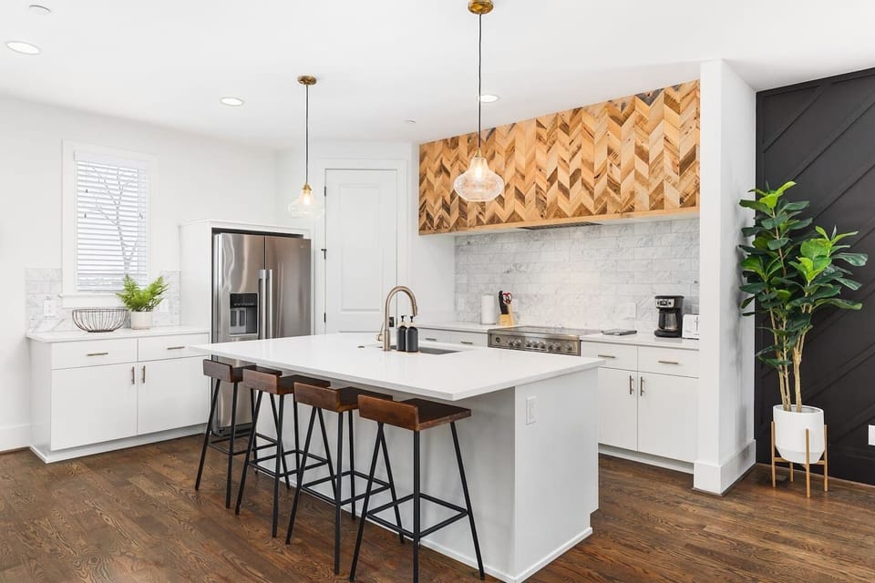 High-end appliances, large pantry, and all the cooking supplies you might need in this bright & fresh kitchen with seating for four at the island.