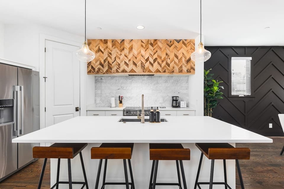 High-end appliances, large pantry, and all the cooking supplies you might need in this bright & fresh kitchen with seating for four at the island.