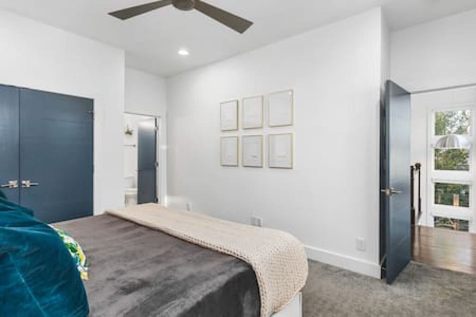 Bedroom #3 with a comfortable king bed, ceiling fan and room-darkening shades. Closet to hang your clothes in plus an ensuite bathroom.