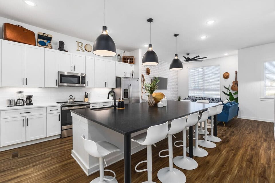 Huge kitchen on the main floor of the house with  a massive island, seating for 10, and all the appliances / supplies you'd need to cook a meal.