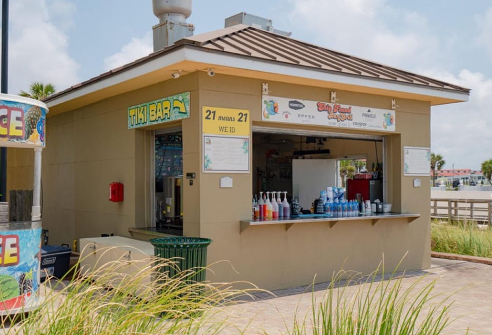 Beachside tiki bar offering refreshing drinks and snacks near your vacation rental location.
