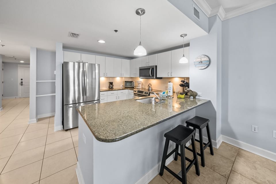 Your spacious kitchen features granite countertops, stainless steel appliances, and a breakfast bar where you can enjoy morning coffee.