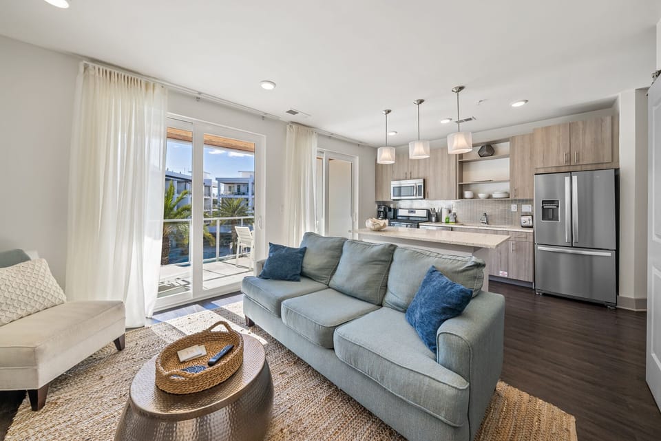 You'll love this bright open-plan space where modern coastal style meets comfort - sink into the plush sofa and enjoy ocean breezes through sliding doors.
