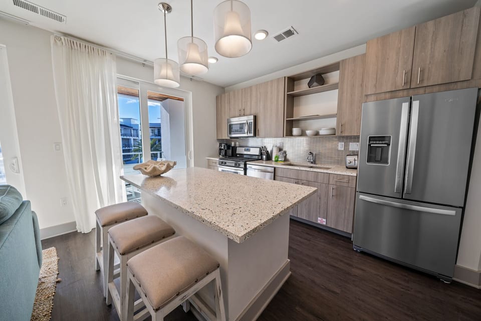 Your modern kitchen awaits with granite island, stainless appliances, and pendant lighting for memorable meal prep.