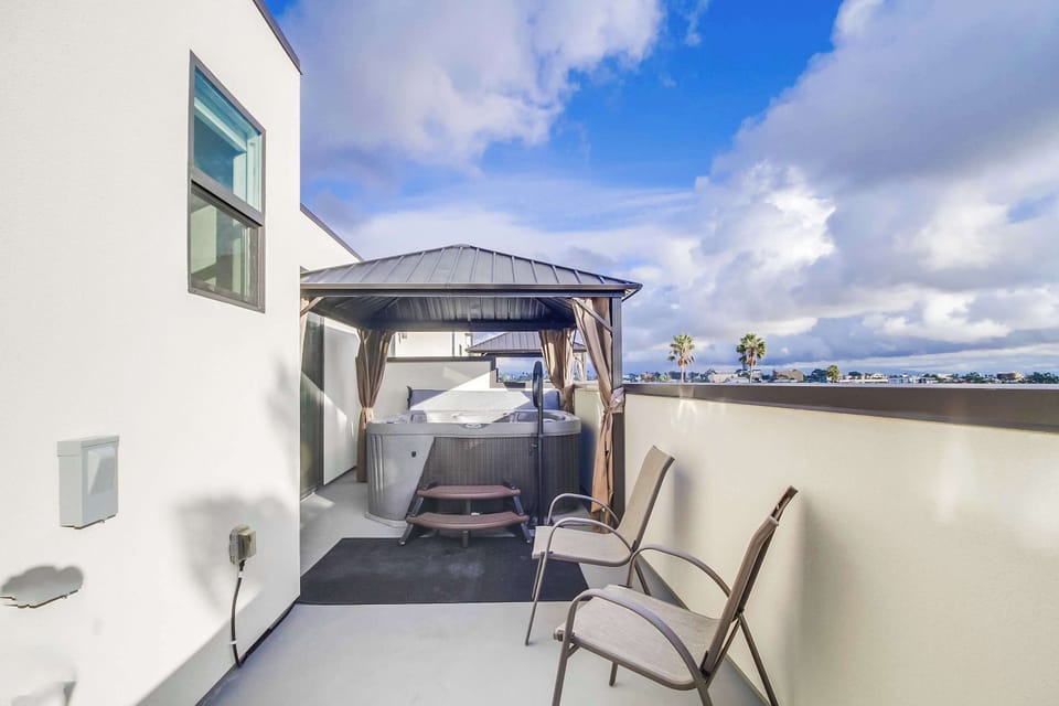 Patio with hot tub and seating