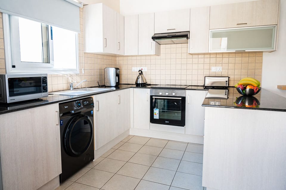 Comfort Apartment, 2 Bedrooms, Pool View | Private kitchen | Coffee/tea maker, full-size fridge, microwave, oven