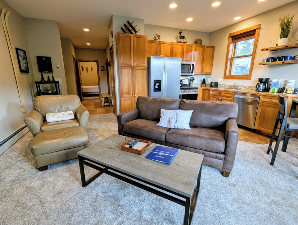 Step into your spacious mountain retreat where comfort meets convenience. Relax on plush leather seating in the bright living area or whip up your favorite meals in the fully equipped kitchen with modern appliances and warm wood cabinetry.
