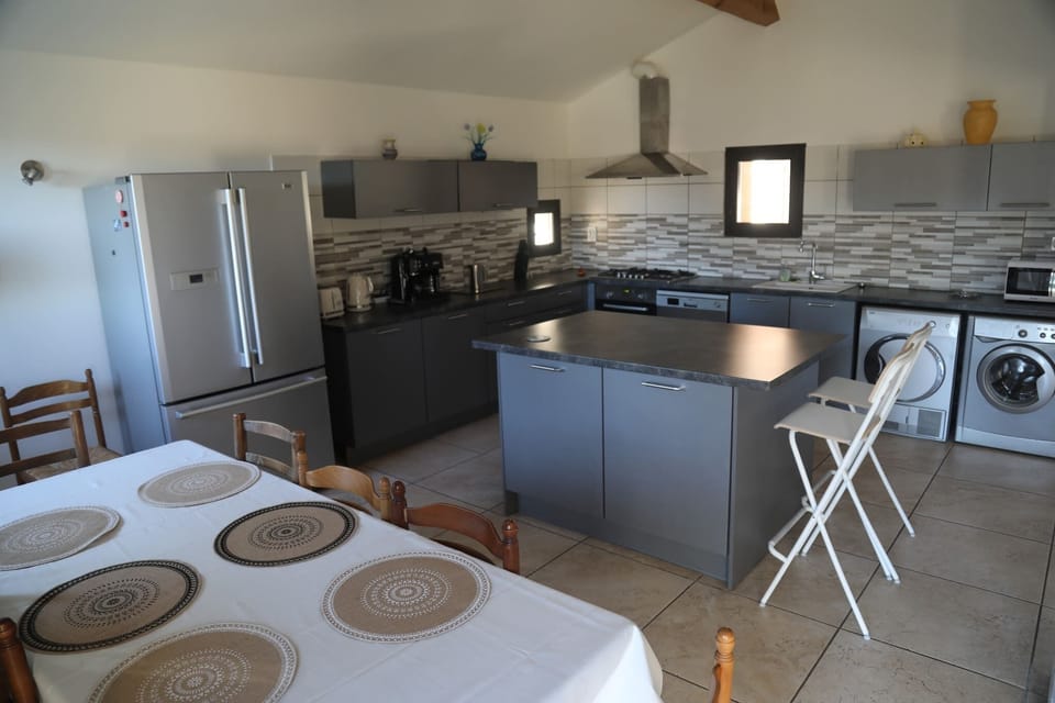 Large, fully equipped kitchen. With space for dining, a large dining table for 8 or the bar for smaller meals.