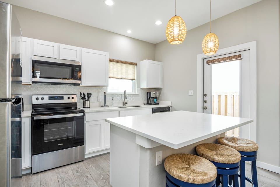 Your fully equipped kitchen features modern appliances and a breakfast bar where you can enjoy morning coffee together.