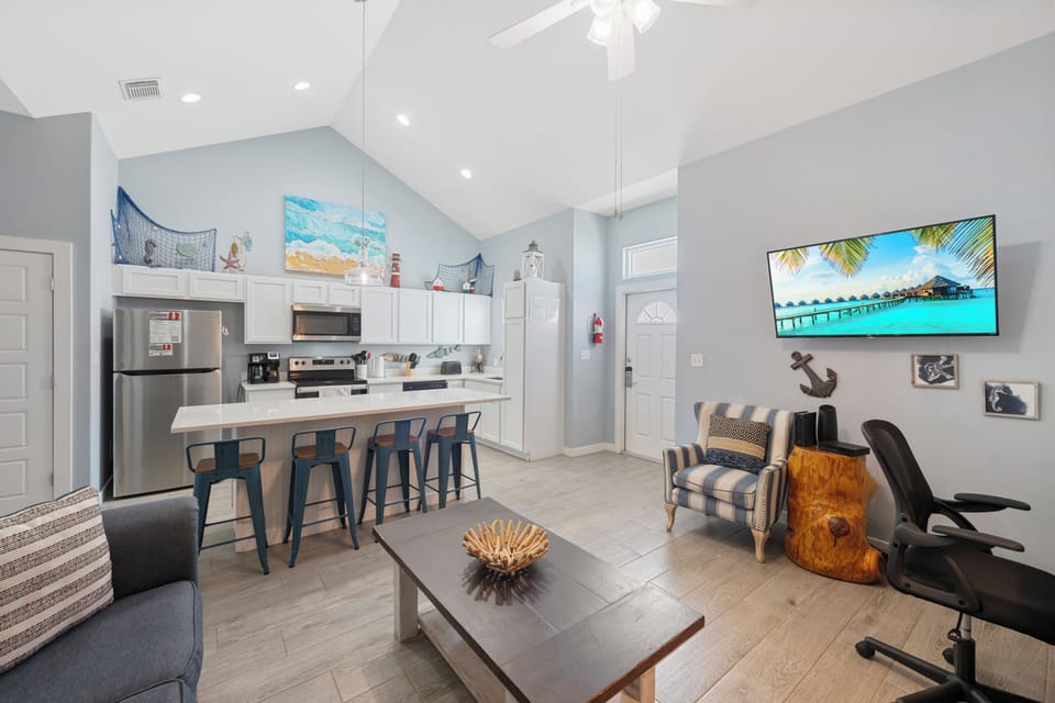 Relax in your bright coastal retreat where nautical touches meet modern comfort, complete with a full kitchen and tropical artwork.
