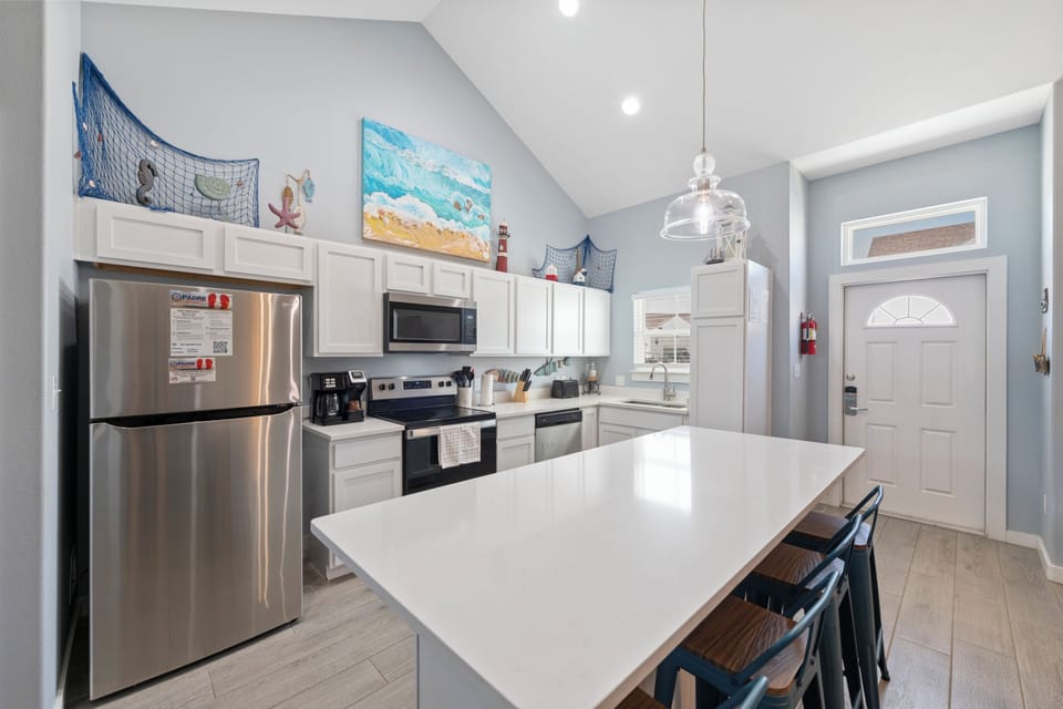 Your fully equipped kitchen features stainless steel appliances and a spacious island for meal prep and casual dining together.