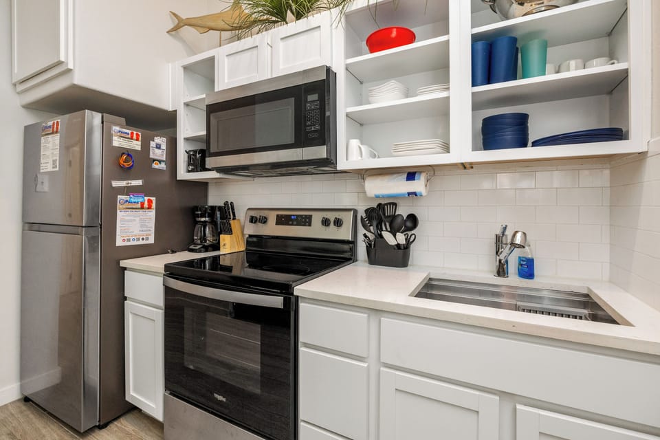 Cook your favorite meals in this fully equipped kitchen with modern appliances, ample storage, and everything you need for comfortable dining.