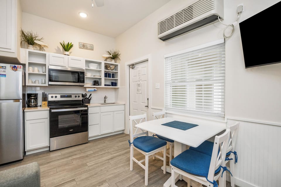 Your bright, fully-equipped kitchen welcomes you with white cabinets, stainless steel appliances, and a cozy dining table for memorable meals.