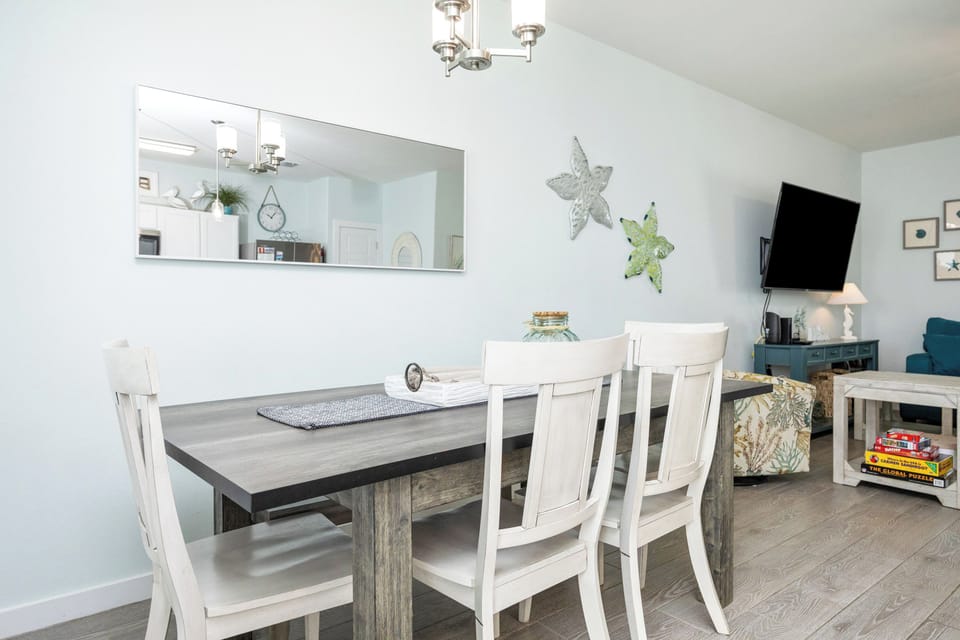Gather around your dining table for memorable meals with coastal charm and modern comfort throughout your stay.