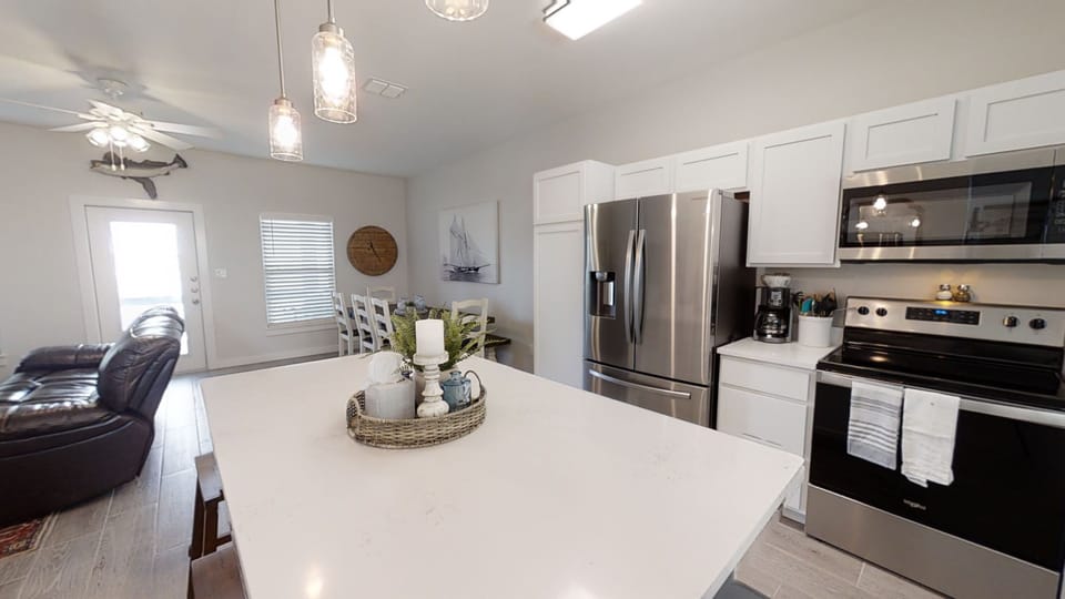Cook with ease in your spacious kitchen featuring modern appliances, quartz countertops, and an open layout perfect for gathering.