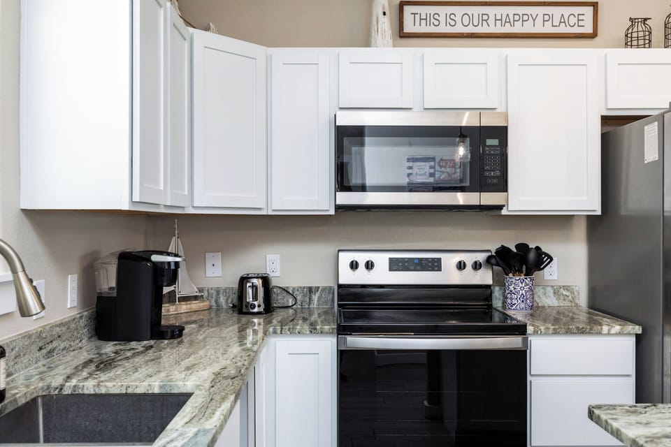 Your fully equipped kitchen with granite countertops and modern appliances makes meal prep a breeze during your stay.