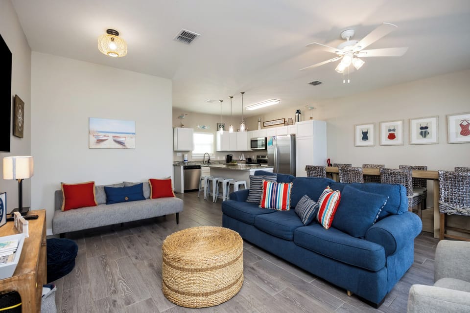 Relax in your open living space with comfortable seating, modern kitchen, and coastal touches throughout.